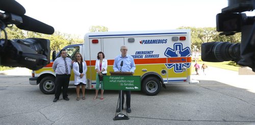 From right, Premier Greg Selinger at podium, Sharon Blady, Minister of Health, Michelle Gawronsky, president, Manitoba Government Employee Union and  Cameron Ritzer, Director, Paramedic Association of Manitoba  in front of a new replacement ambulance parked by the Manitoba Legislative Bld. Tuesday.   The province announced it has purchased 52 new ambulances with new suspension system and other features.   Larry Kusch story Wayne Glowacki / Winnipeg Free Press Sept.1  2015