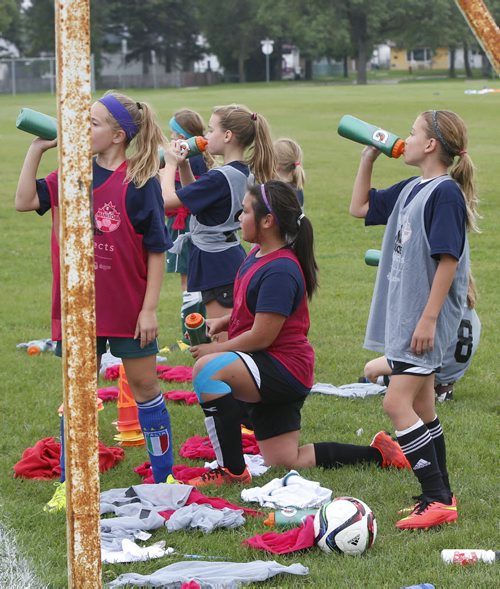 Young soccer players take a water break during drills at Shaughnessy Park Thursday.  Bart Choufour, Head Coach U14 Residency and Head Coach Academy Centres at Vancouver Whitecaps FC  was here watching the 9-12 year old boys and girls trying out for future development programs.  Tim Campbell story. Wayne Glowacki / Winnipeg Free Press Sept.3  2015