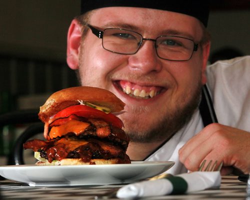 DIner's Grill owner and Chef Joshua Mesojednik poses with, signature sandwich the Double Diners Cheeseburger. See Dave Sanderson story.  Sept 3, 2015 - (Phil Hossack / Winnipeg Free Press)