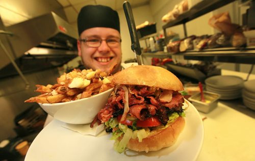 DIner's Grill owner and Chef Joshua Mesojednik serves up hearty chow at his St Boniface Industrial Park eatery, including this Diners Ruben Burger featuring almost a pound of combined meats. See Dave Sanderson story.  Sept 3, 2015 - (Phil Hossack / Winnipeg Free Press)
