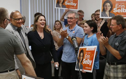 Provincial MLA Erin Selby passes between MLAs Bidhu Jha,left and Stan Struthers as she heads to the podium to announce Friday morning she will be the federal NDP candidate in St. Boniface-St. Vital. to an exuberant  crowd at the Glenwood Community Centre .Larry Kusch / Nick Martin stories Wayne Glowacki / Winnipeg Free Press Sept.4  2015