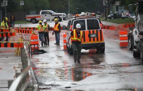 Crews clean up near 630 PM after draining water on the  Ness Ave bridge over the Sturgeon Creek that accumulated from Friday afternoons storm- Standup Photo- Sept 04, 2015   (JOE BRYKSA / WINNIPEG FREE PRESS)