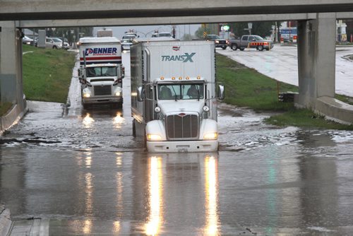 Only semi trailers were being let through by police north bound on Route 90 near Logan because of deep water from todays storm in the underpass-South bound lanes are still blocked by two flooded cars and traffic is being diverted- Breaking News- Aug 28, 2015   (JOE BRYKSA / WINNIPEG FREE PRESS)