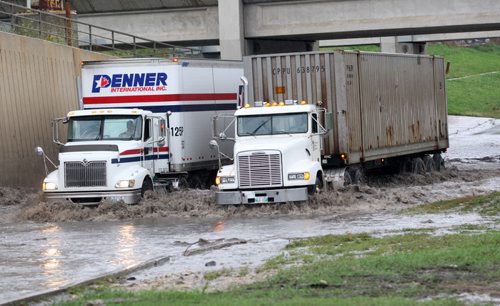 Only semi trailers were being let through by police north bound on Route 90 near Logan because of deep water from todays storm in the underpass-South bound lanes are still blocked by two flooded cars and traffic is being diverted- Breaking News- Aug 28, 2015   (JOE BRYKSA / WINNIPEG FREE PRESS)
