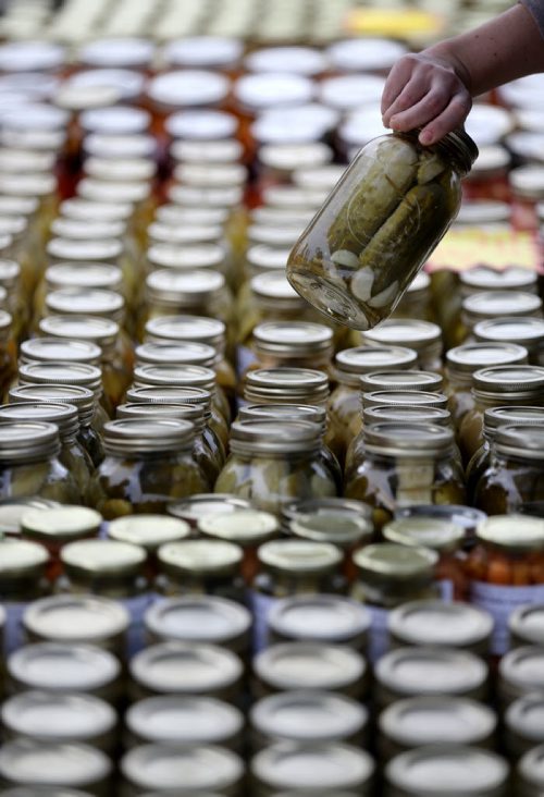 A customer shops for pickles at Grammie's Jams, Jellys and Preserves, at the St.Norbert Farmers Market, Saturday, September 5, 2015. (TREVOR HAGAN/WINNIPEG FREE PRESS)