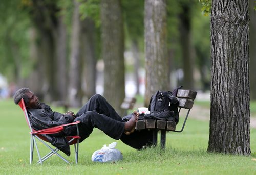 A man naps in Assiniboine Park, Saturday, September 5, 2015. (TREVOR HAGAN/WINNIPEG FREE PRESS)