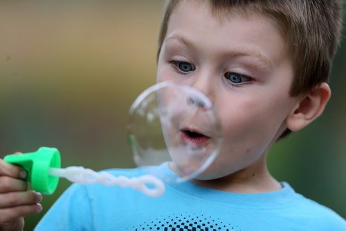 Lincoln Gundrum, 4, blows a bubble in Assiniboine Park, Saturday, September 5, 2015. (TREVOR HAGAN/WINNIPEG FREE PRESS)