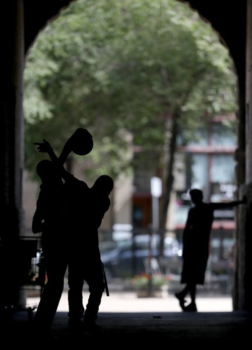 Three men play basketball in an alley between King Street and Arthur Street, Sunday, September 6, 2015. (TREVOR HAGAN/WINNIPEG FREE PRESS)
