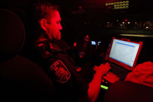 Police ride along curfew checks. Based out of east district police station, on Dugald Road.  In this photo Constable Cal Bailey in the cruiser. BORIS MINKEVICH / WINNIPEG FREE PRESS PHOTO Sept. 3, 2015