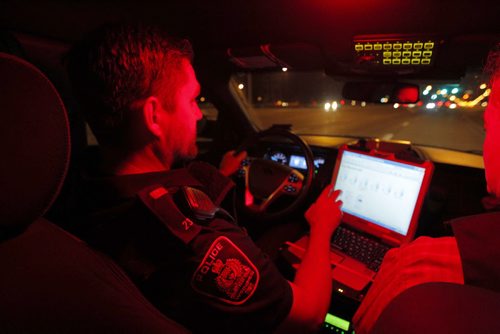 Police ride along curfew checks. Based out of east district police station, on Dugald Road.  In this photo Constable Cal Bailey in the cruiser. BORIS MINKEVICH / WINNIPEG FREE PRESS PHOTO Sept. 3, 2015