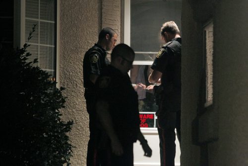 Police ride along curfew checks. Based out of east district police station, on Dugald Road.  In this photo Constable Cal Bailey, r, and two other police officers check for curfew at several locations. BORIS MINKEVICH / WINNIPEG FREE PRESS PHOTO Sept. 3, 2015