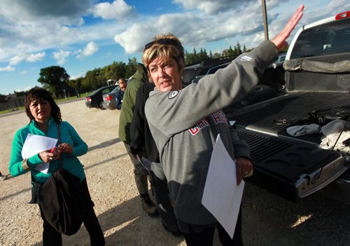 Lori Wolsteneroft hands out map and directs volunteers in a search for her sister-in-law Jill Tardiff in and around Whittier Park Tuesday evening. Recently released from hospital Jill went missing early Monday morning. See Ashley Prest story. September 8, 2015 - (Phil Hossack / Winnipeg Free Press)