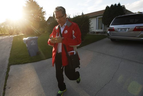 September 8, 2015 - 150908 - Liberal candidate Dan Vandel checks his voter analytics on his phone as he door knocks in his St Boniface/St Vital riding Tuesday, September 8, 2015. John Woods / Winnipeg Free Press
