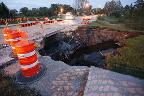 September 8, 2015 - 150908 - Erosion caused by a damaged drainage culvert has closed down Ness Avenue at Sturgeon Creek Tuesday, September 8, 2015. John Woods / Winnipeg Free Press