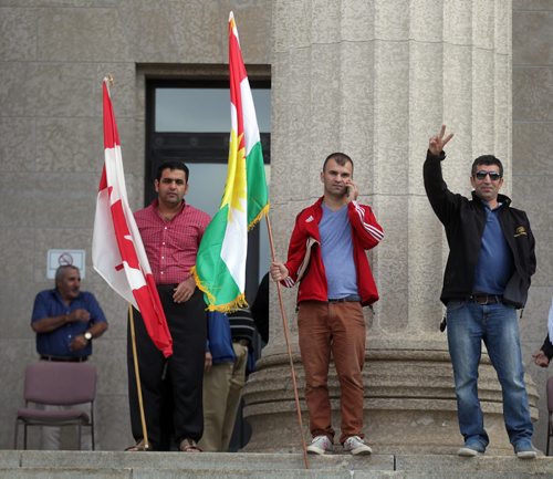 Waving the Canadian and Kurdish Flags, members of Manitoba's Kurdish Community rally at the Legislature Wednesday afternoon under the Kurdish Flag. See Ashley Prest story. September 9, 2015 - (Phil Hossack / Winnipeg Free Press)