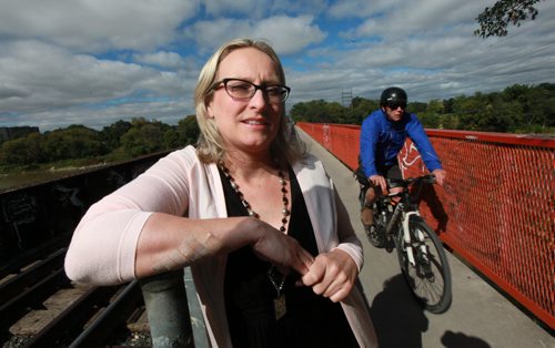 Yoko Chapman poses on the pedestrian walkway where she gashed her arm on a "love lock". The wound required 21 stotches. See Gord Sinclair story. September 9, 2015 - (Phil Hossack / Winnipeg Free Press)