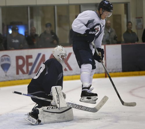 Winger Nikolaj Ehlers tries to block the view of goaltender Eric Comrie during a scrimmage at the Winnipeg Jets rookie camp at the MTS Iceplex Thursday. Ed Tait story. Wayne Glowacki / Winnipeg Free Press September 10 2015