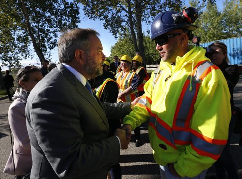 At left, NDP Leader Tom Mulcair shakes  hands with Tyler Murphy enrolled at the at the Operating Engineers Training Institute of Manitoba Inc. where Mulcair  made an announcement in Winnipeg Thursday morning. Larry Kusch story. Wayne Glowacki / Winnipeg Free Press September 10 2015