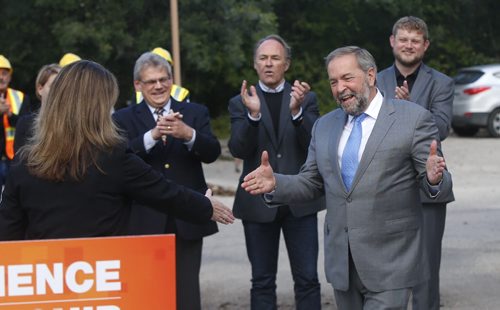 NDP Leader Tom Mulcair is welcomed to the podium by NDP candidate Erin Selby to make an announcement at the Operating Engineers Training Institute of Manitoba Inc. in Winnipeg Thursday morning. Wayne Glowacki / Winnipeg Free Press September 10 2015