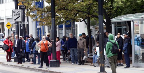 Riders wait at the bus stop on Graham Ave. at Smith Street Thursday. Winnipeggers will have to get used to a reduced level of Transit service as the department struggles with a manpower shortage and problematic buses.Ashley Prest story Wayne Glowacki / Winnipeg Free Press September 10 2015