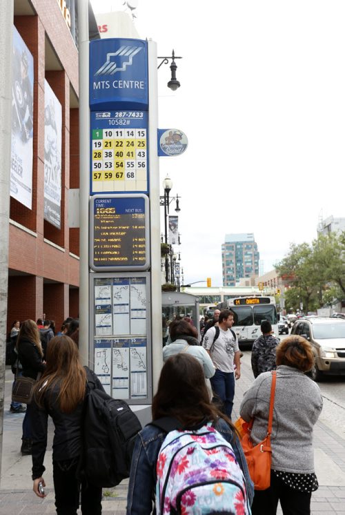 Riders wait at the bus stop on Portage Ave. at Donald Thursday. Winnipeggers will have to get used to a reduced level of Transit service as the department struggles with a manpower shortage and problematic buses.Ashley Prest story Wayne Glowacki / Winnipeg Free Press September 10 2015