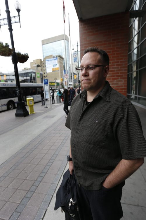 Brian Fotheringham waits at the bus stop on Portage Ave. at Donald Thursday. Winnipeggers will have to get used to a reduced level of Transit service as the department struggles with a manpower shortage and problematic buses.Ashley Prest story Wayne Glowacki / Winnipeg Free Press September 10 2015