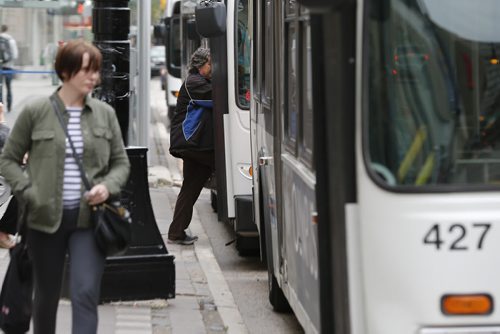 September 10, 2015 - 150910 - Bus passengers load buses in downtown Winnipeg Thursday, September 10, 2015. Winnipeg Transit say they have a shortage of buses due to maintenance delays. John Woods/Winnipeg Free Press