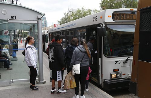 Riders board a bus on Portage Ave. at Donald St. Thursday. Winnipeggers will have to get used to a reduced level of Transit service as the department struggles with a manpower shortage and problematic buses.Ashley Prest story Wayne Glowacki / Winnipeg Free Press September 10 2015