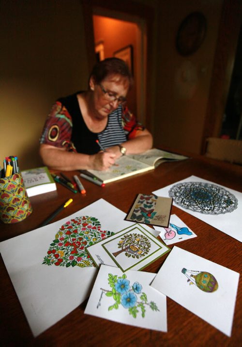 Wendy Molnar and her "coloring" books, this is for an Intersection piece on a crazy fad - adult colouring books. They're big, big, big these days and Wendy has 10 or so on her shelves, which she colours as a form of relaxation. So shots of Wendy in "action". See Dave Sanderson story. September 10, 2015 - (Phil Hossack / Winnipeg Free Press)