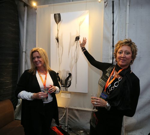 QX104 employees Samantha Stevens (left) and Heidi Rasmussen check out some of the art on display in the Rendez-Vous VIP tent at Cavalias equestrian and acrobatic-arts show Odysseo on Thurs., Sept. 10, 2015. Photo by Jason Halstead/Winnipeg Free Press