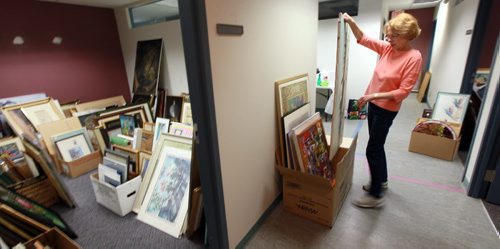 Heather Colquhoun sorts through  donated art amassed for the "Art from the Attic Sale" on Sept 20  its organized by GrandsnMore to raise money for Stephen Lewis Fdn helping AIDS orphans in Africa who are being raised by their grannies. Its one Cdn charity thats helping people help themselves so they can maintain a civil society and dont end up in chaos and driven from their homes as refugees or economic migrants. September 11, 2015 - (Phil Hossack / Winnipeg Free Press) SEE RELEASE?