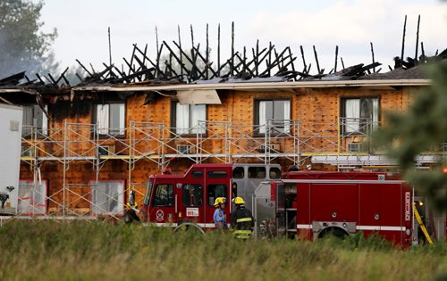 Firefighters at the scene of a fire in a Super 8 motel on Niakwa Road East, Friday, September 11, 2015. (TREVOR HAGAN/WINNIPEG FREE PRESS)