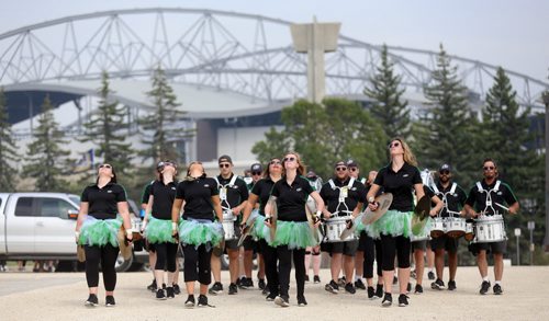 The Saskatchewan Roughrider Drumline, walks through a parking lot full of tailgaters, prior to the Banjo Bowl, Saturday, September 12, 2015. (TREVOR HAGAN/WINNIPEG FREE PRESS)