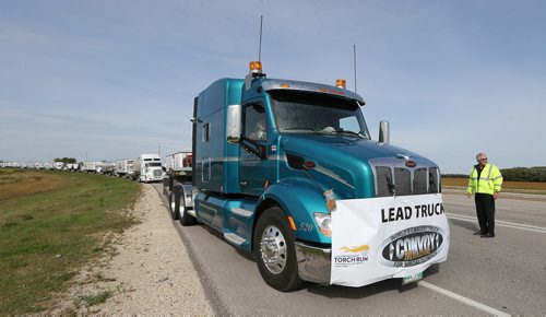John Oades of Beaver Truck Centre and chairman of associated trades for the Manitoba Trucking Association gets the worlds largest truck convoy gets rolling on the the Perimeter Highway on Sept. 12, 2015. The 8th annual convoy, which runs in conjunction with members of the trucking industry and Manitoba Trucking Association, raises funds and awareness for Special Olympics Manitoba. Since its inception in 2001, the convoy has raised over $4 million in Canada and the U.S. In 2014. This year, 185 trucks took part. Photo by Jason Halstead/Winnipeg Free Press