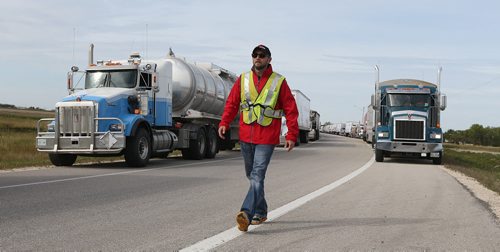 Manitoba Trucking Association executive director Terry Shaw gets the worlds largest truck convoy gets rolling on the the Perimeter Highway on Sept. 12, 2015. The 8th annual convoy, which runs in conjunction with members of the trucking industry and Manitoba Trucking Association, raises funds and awareness for Special Olympics Manitoba. Since its inception in 2001, the convoy has raised over $4 million in Canada and the U.S. In 2014. This year, 185 trucks took part. Photo by Jason Halstead/Winnipeg Free Press