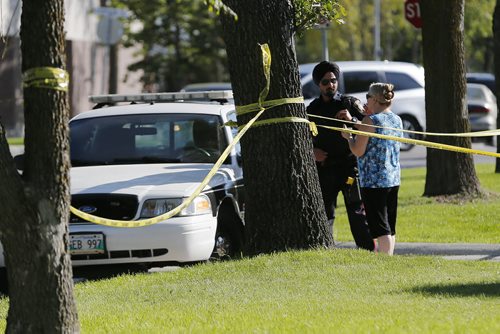 September 13, 2015 - 150913  -  Police talk to a woman who's brother was discovered dead at 435 Lanark Street Sunday, September 13, 2015. Police are investigating it as a suspicious death. John Woods / Winnipeg Free Press
