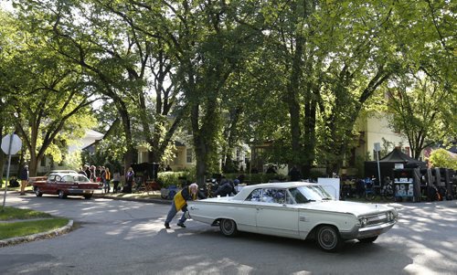 A vintage car is moved out of view on Baltimore Rd. in Riverview Monday during the making of the movie A Dog's Purpose with Dennis Quaid.  Randall King story.  Wayne Glowacki / Winnipeg Free Press September 14 2015