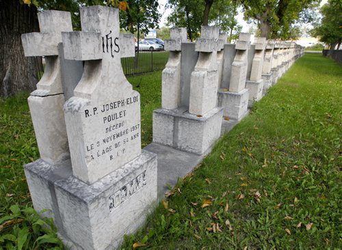 NEWS - MOVING PRIESTS GRAVES - Approximately 60 graves on the grounds of the Franco-Manitoban Cultural Centre in St. Boniface will be exhumed in fall. A cemetery established in 1913 by the Oblate Fathers, a Catholic religious order, is to be moved from its site at Des Meurons Street and Provencher Boulevard. The construction association website has an invitation to bid to disinter and move the cemetery. The old cemetery has stones dating back to at least 1914 and is located in St. Boniface. Near the corner of  BORIS MINKEVICH / WINNIPEG FREE PRESS PHOTO Sept. 14, 2015