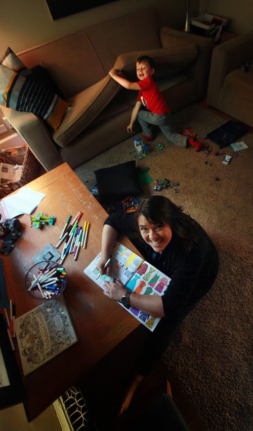 This is for an Intersection piece on adult colouring books and the adults who love 'em...  shots of Robin Summerfield colouring away - she usually sets up on the floor in her living room - that's her preferred space - she also colours with her 5-year-old son Will who isnt into colouring, but keeps his mom comapny while she stays between the lines...September 14, 2015 - (Phil Hossack / Winnipeg Free Press)