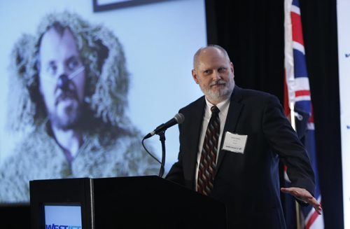 Rocky Wiggins, CIO WestJet at the podium to announce cheap flights from Winnipeg to London Gatwick. He is showing the TV commercial featuring "Dave the Dog" that will be aired in the UK to attract travellers to Canada. The event Tuesday was held in the Fairmont Hotel. Bart Kives story.  Wayne Glowacki / Winnipeg Free Press September 15 2015