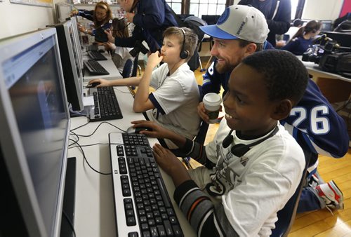 Winnipeg Jets player, Blake Wheeler with Dufferin School  students Sterling McLeod, right, and Kathius  Allan for the launch of the Future Goals  Hockey ScholarTM learning course that is a new North American digital education initiative that provides students with science, technology, engineering, and math (STEM) learning opportunities. The National Hockey League Players' Association and the NHL's new hockey-themed education course uses real hockey examples that include the dynamics of the ice surface, equipment design, athletic performance, and geometric and energy considerations, all relating to how the game is played.  This is part of the  Future Goals Program that was launched in September 2014 and has reached  students  in  3,500 schools throughout the United States and Canada.    see release. Wayne Glowacki / Winnipeg Free Press September 15 2015