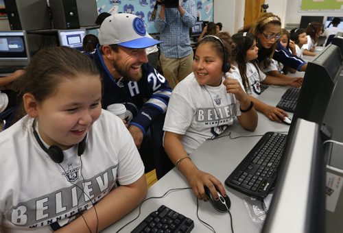 Winnipeg Jets player, Blake Wheeler with Dufferin School  students Donna Ahmo,left,  and Falicity Klyne for the launch of the Future Goals  Hockey ScholarTM learning course that is a new North American digital education initiative that provides students with science, technology, engineering, and math (STEM) learning opportunities. The National Hockey League Players' Association and the NHL's new hockey-themed education course uses real hockey examples that include the dynamics of the ice surface, equipment design, athletic performance, and geometric and energy considerations, all relating to how the game is played.  This is part of the  Future Goals Program that was launched in September 2014 and has reached  students  in  3,500 schools throughout the United States and Canada.    see release. Wayne Glowacki / Winnipeg Free Press September 15 2015