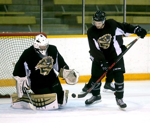 Liam Bilton, right, flips the puck on net, during University of Manitoba Bisons' hockey practice at Wayne Fleming Arena, Tuesday, September 15, 2015. (TREVOR HAGAN/WINNIPEG FREE PRESS)