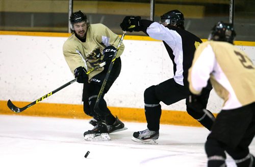 Brett Stovin, left, passes the puck during University of Manitoba Bisons' hockey practice at Wayne Fleming Arena, Tuesday, September 15, 2015. (TREVOR HAGAN/WINNIPEG FREE PRESS)