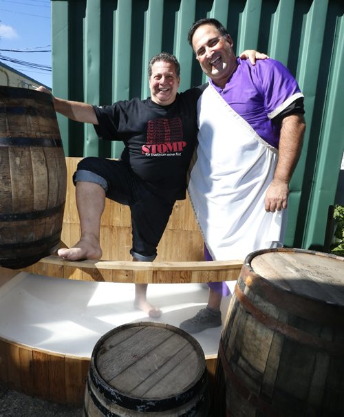 To promote the up coming 2nd Annual "STOMP",  Joe Grande, owner of the local Italian eatery Mona Lisa at left  poses with Joe Aiello who will be MC for the event on Sept 27. They are in the "barrel" where the grape will be stopped upon. Doug Speirs story Wayne Glowacki / Winnipeg Free Press September 16 2015