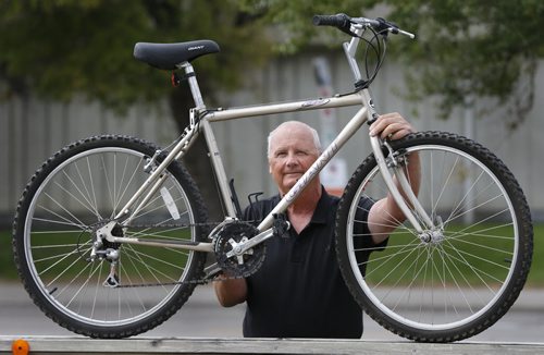 Randy Burkett with his stolen bike that he bought back for $70 on Kijiji from the person he believes was the thief. Gord Sinclair story Wayne Glowacki / Winnipeg Free Press September 16 2015