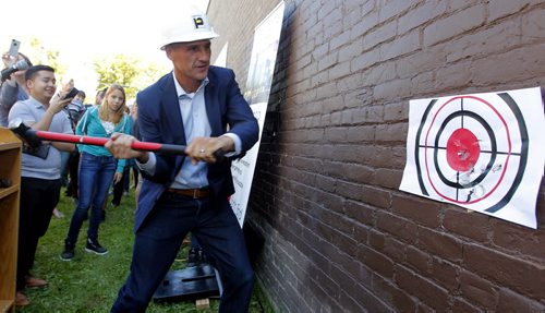 LOCAL - MERCHANTS HOTEL,  541 Selkirk Ave - Merchants Corner community event. The first sledgehammer swings at the old Merchants Hotel which is being transformed into an educational and affordable housing complex. MLA Kevin Chief gets a chance to smash the wall. BORIS MINKEVICH / WINNIPEG FREE PRESS PHOTO Sept. 16, 2015