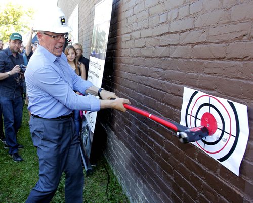 LOCAL - MERCHANTS HOTEL,  541 Selkirk Ave - Merchants Corner community event. The first sledgehammer swings at the old Merchants Hotel which is being transformed into an educational and affordable housing complex. Manitoba Premier Greg Selinger take the hammer to the building. BORIS MINKEVICH / WINNIPEG FREE PRESS PHOTO Sept. 16, 2015