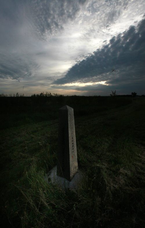 Lonely Sentinel, a boundary marker sits in a ditch near Emerson on th Canadian side of the international boundary. September 16, 2015 - (Phil Hossack / Winnipeg Free Press) See Carol Sanders story, BUSY SUMMER ON MANITOBAS UNDERGROUND RAILROAD  -- While thousands seeking asylum in Europe amass on its borders, a growing surge of refugee claimants quietly slip into Canada under the cover of darkness at a Manitoba border town. Most local residents dont see them because they arrive under the cover of darkness while people are sleeping, said Wayne Arseny, Emersons former mayor. They dont want be to be spotted. CBSA says nearly twice as many asylum seekers   walked up to the port of entry into Canada by way of Manitoba this summer compared to last  year. Some in the settlement community are calling the influx the underground railroad with many refugee claimants crossing here and moving on to Toronto and B.C.  Why here? Why now? What does it mean for Winnipeg and its already overwhelmed settlement services? 15 SANDERS (ART?)