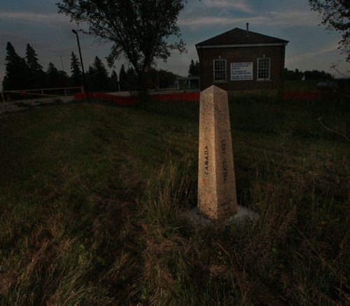 Lonely Sentinel, a boundary marker at the former (closed) border crossing to Noyes Minessota on the Canadian side of the international boundary. September 16, 2015 - (Phil Hossack / Winnipeg Free Press)   See Carol Sanders story, BUSY SUMMER ON MANITOBAS UNDERGROUND RAILROAD  -- While thousands seeking asylum in Europe amass on its borders, a growing surge of refugee claimants quietly slip into Canada under the cover of darkness at a Manitoba border town. Most local residents dont see them because they arrive under the cover of darkness while people are sleeping, said Wayne Arseny, Emersons former mayor. They dont want be to be spotted. CBSA says nearly twice as many asylum seekers   walked up to the port of entry into Canada by way of Manitoba this summer compared to last  year. Some in the settlement community are calling the influx the underground railroad with many refugee claimants crossing here and moving on to Toronto and B.C.  Why here? Why now? What does it mean for Winnipeg and its already overwhelmed settlement services? 15 SANDERS (ART?)